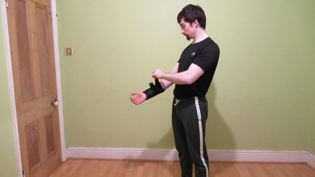 A man fastening his forearm brace