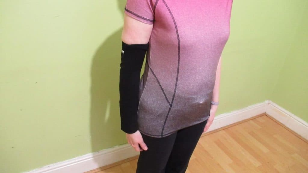 A woman wearing a forearm compression sleeve for tendonitis