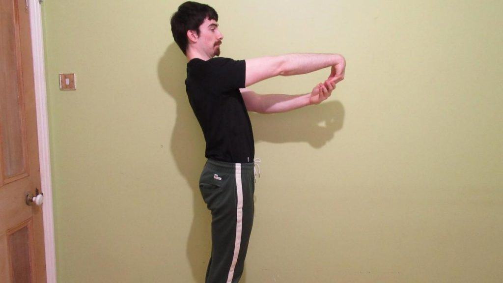 A man performing a forearm extensor stretch