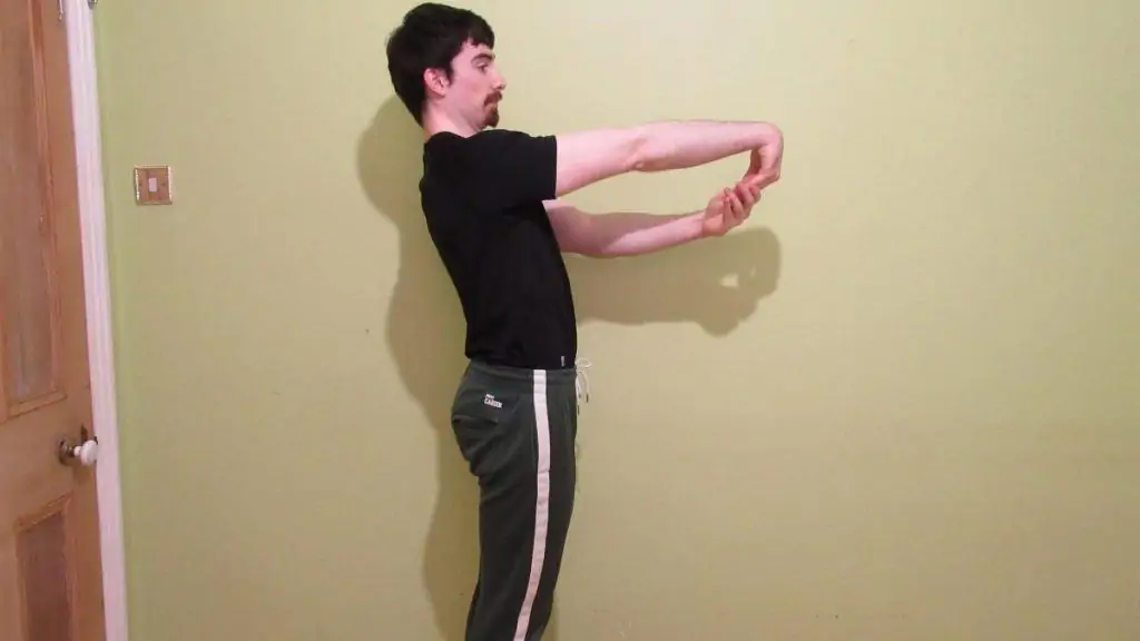 A man performing a forearm extensor stretch