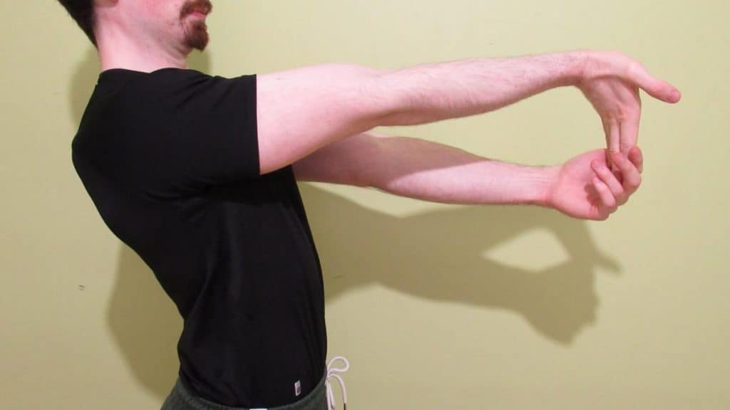 A man performing a forearm flexor stretch to loosen up his muscles