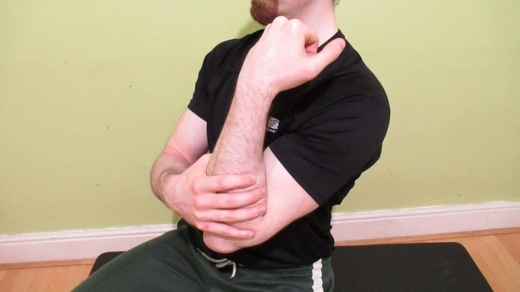 A man showing that his forearm hurts after lifting weights