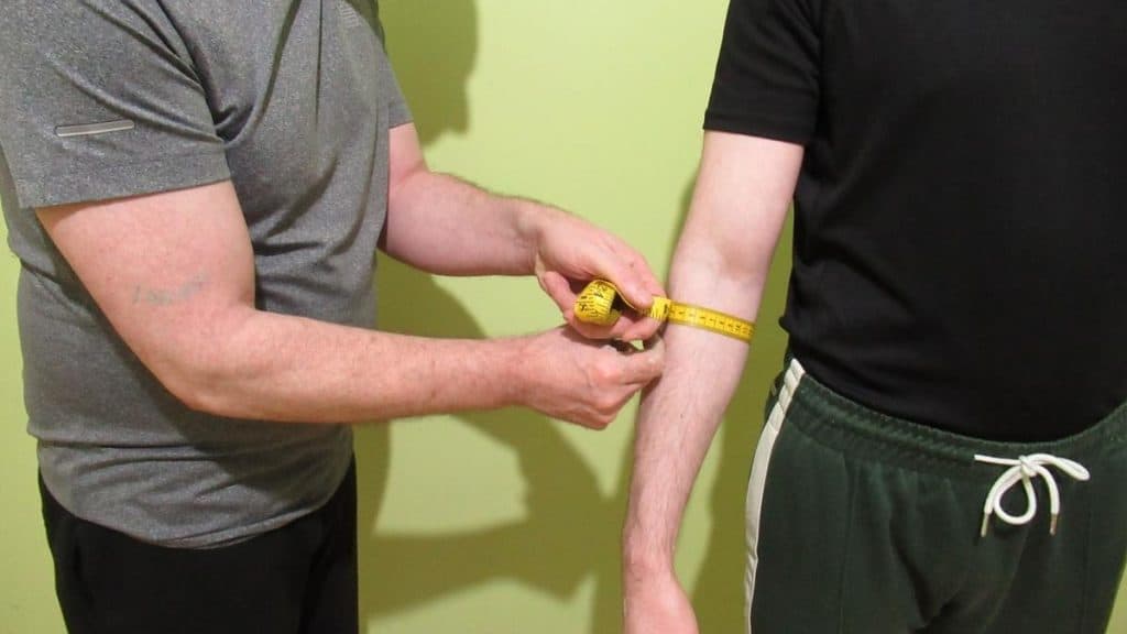 A man having his forearm measurement taken