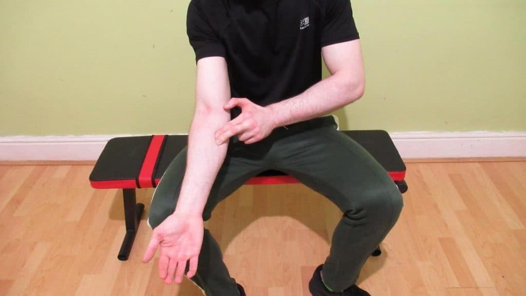 A man performing some forearm self massage