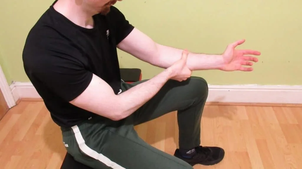 A man exhibiting one of the most common forearm strain symptoms; flexor pain