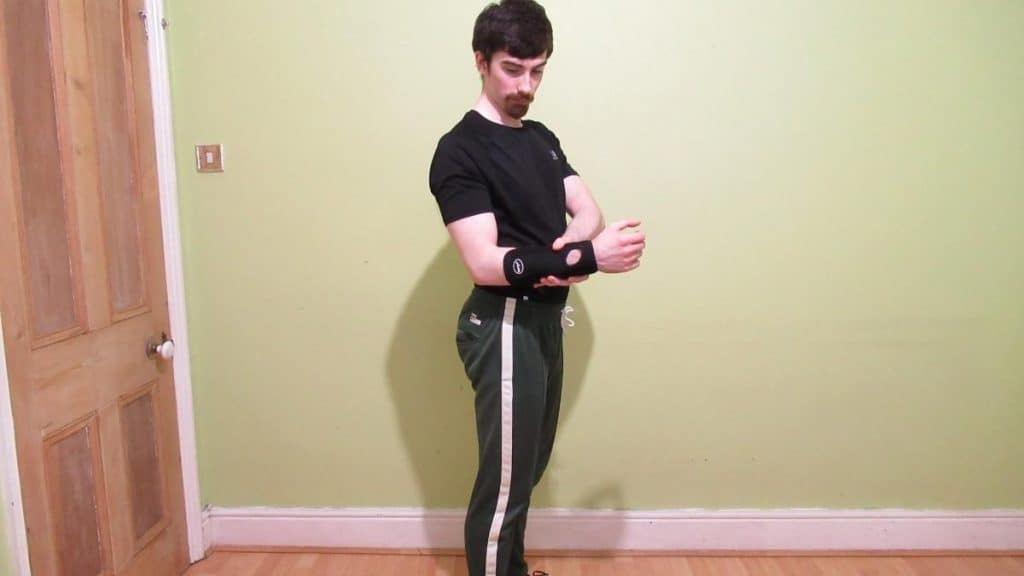 A man wearing a forearm support brace because he has tendonitis