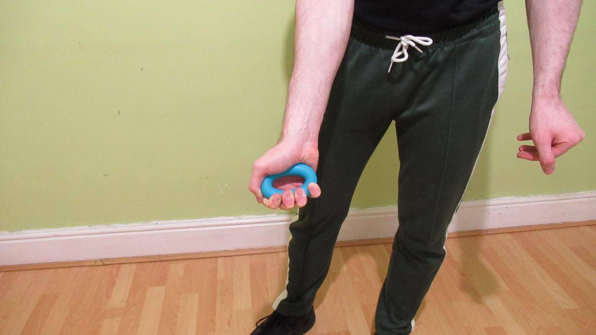 A man using a forearm trainer that's made by Black Diamond