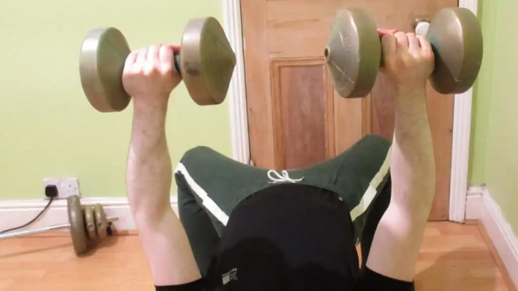 A man demonstrating how the forearms get worked during the bench press