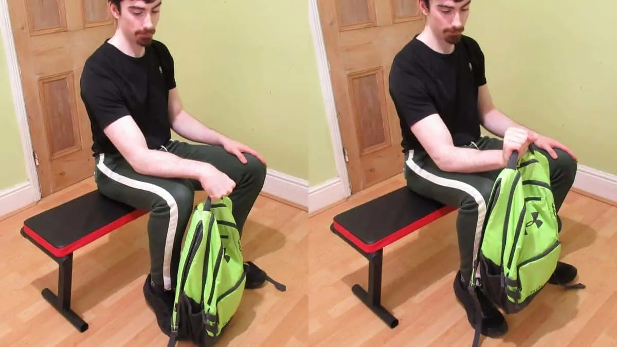 A man doing a forearms workout with a backpack