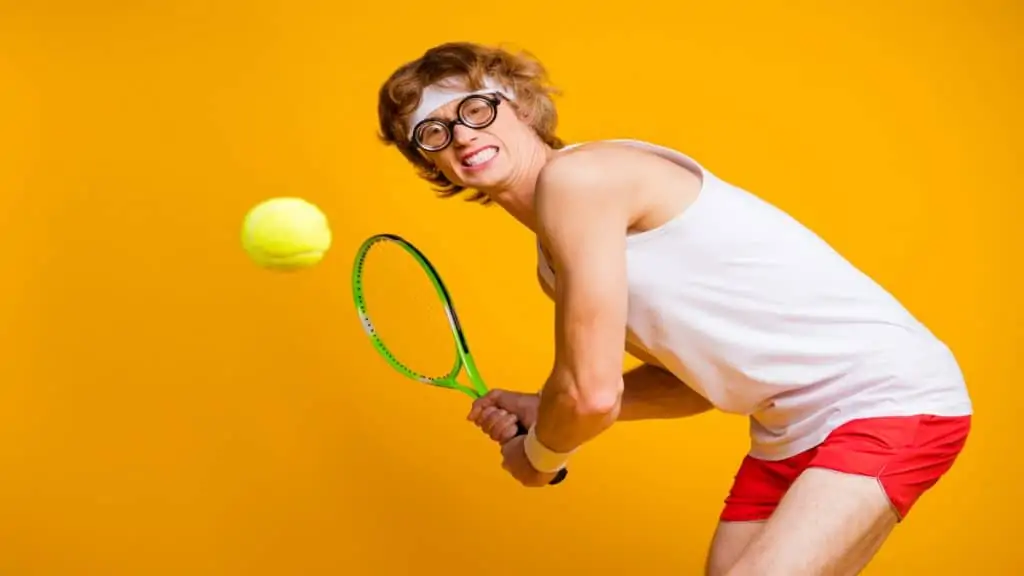 A geeky tennis player swinging his racket