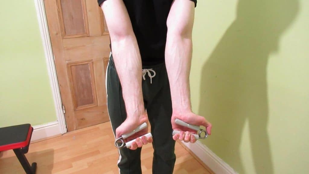A man performing hand grip squeezes
