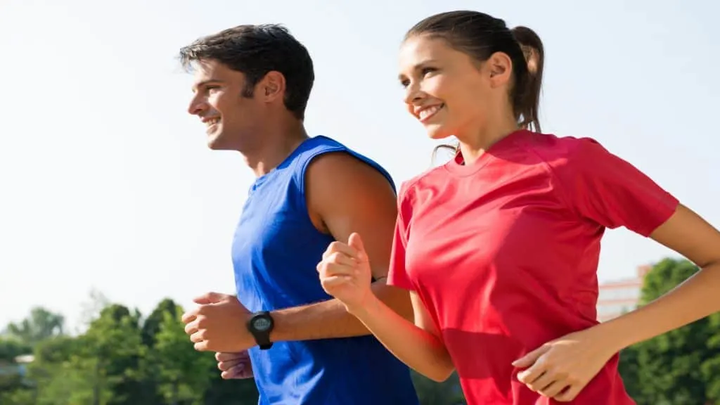 A happy couple jogging in the park