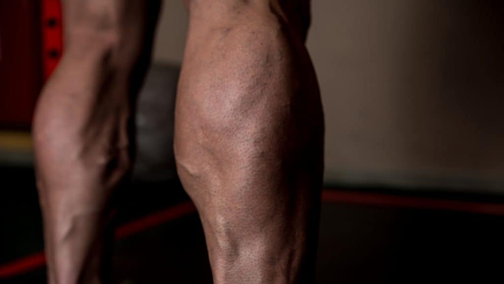 A man showing how big your calves should be if you go to the gym