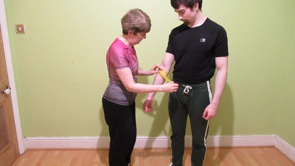 A woman showing how to measure your forearm circumference accurately
