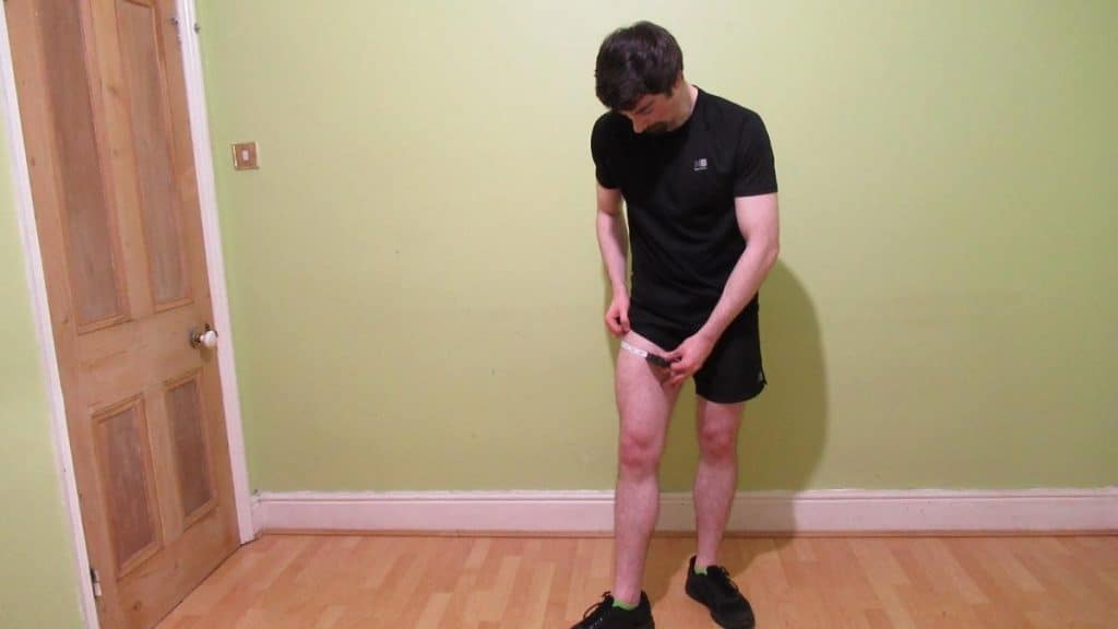 A man demonstrating how to measure your thigh circumference