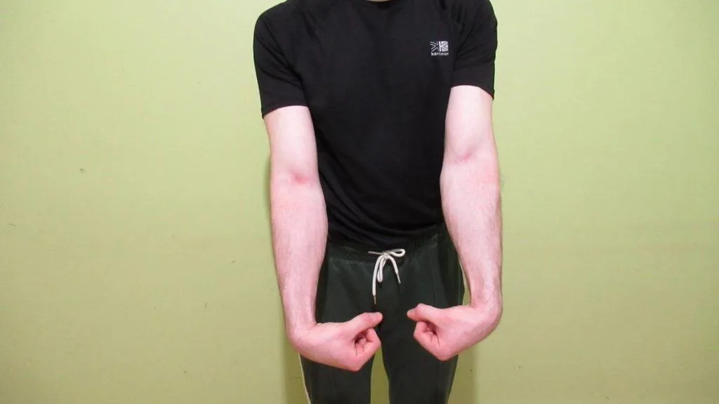 A man showing how to work out your forearms without weights