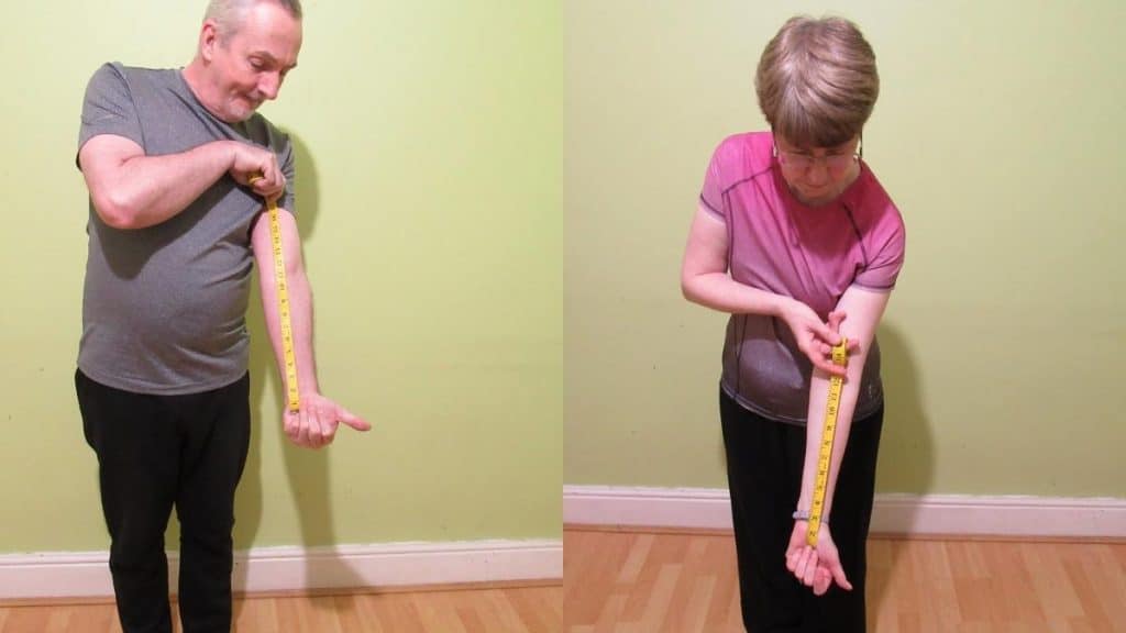 A man and a woman seeing how long their forearms are