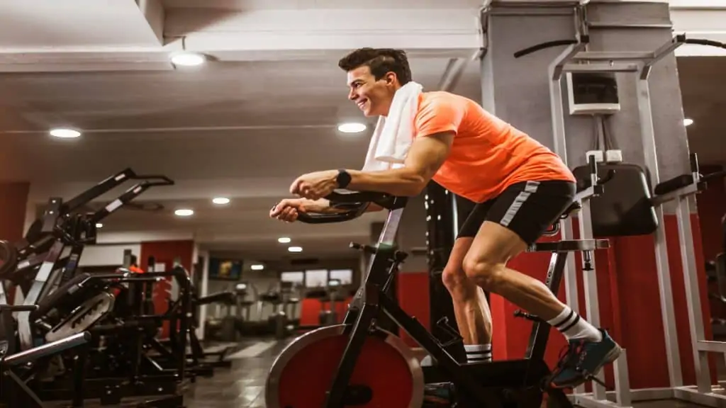 A man using an exercise bike at the gym