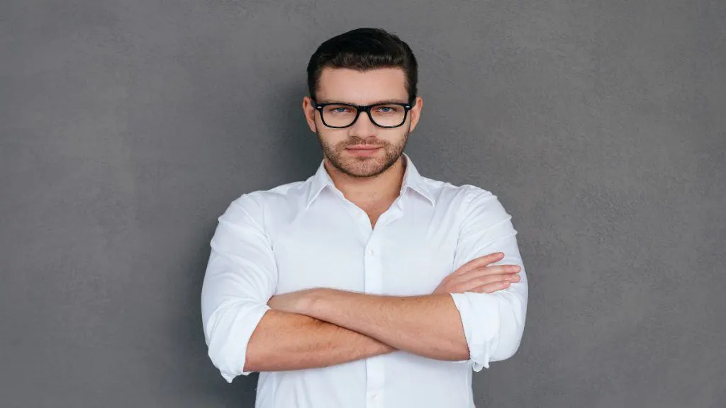 A man in a shirt folding his arms