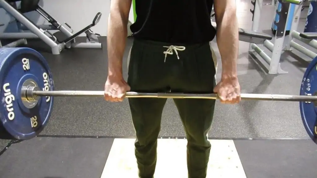 A man gripping a barbell