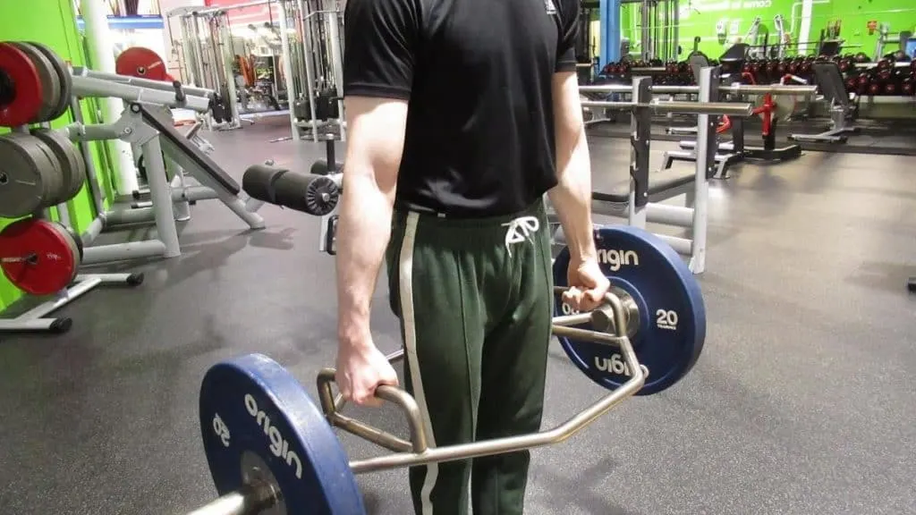 A man gripping a trap bar