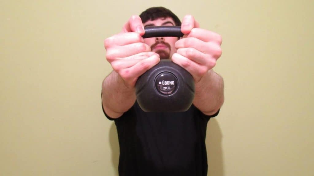 A man holding a kettlebell