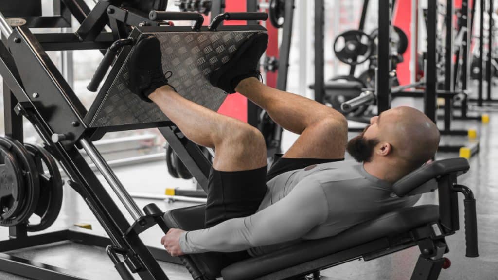 A man doing a leg press at the gym