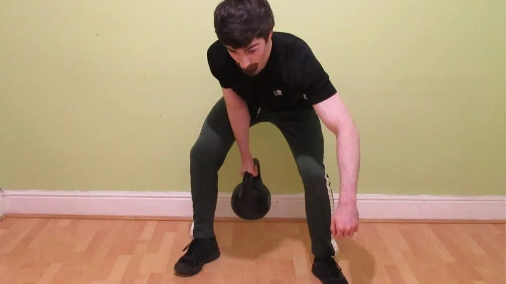 A man swinging a kettlebell