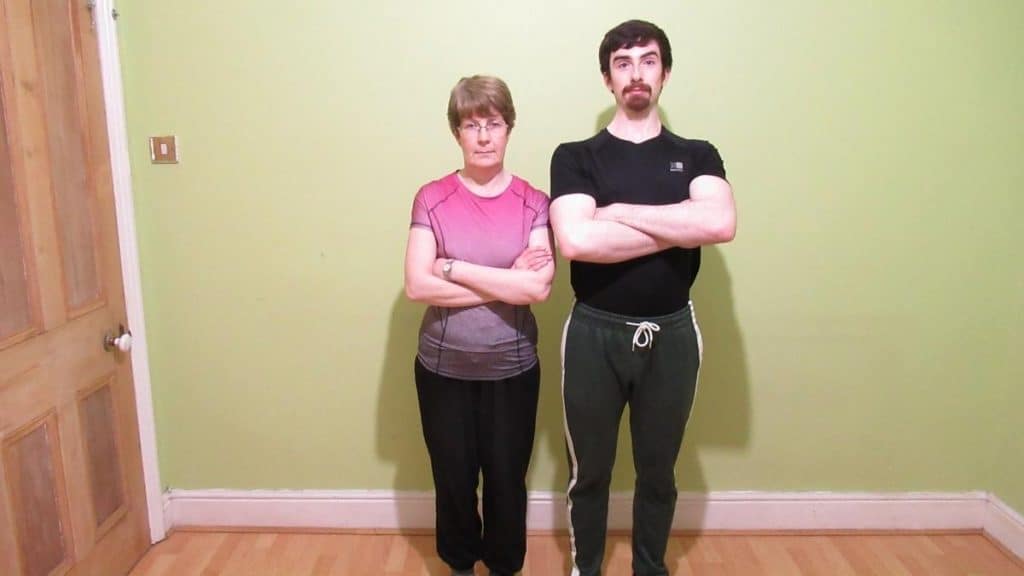 A man and a woman standing with their arms folded