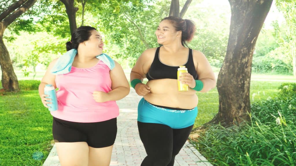 Two overweight woman running in the park