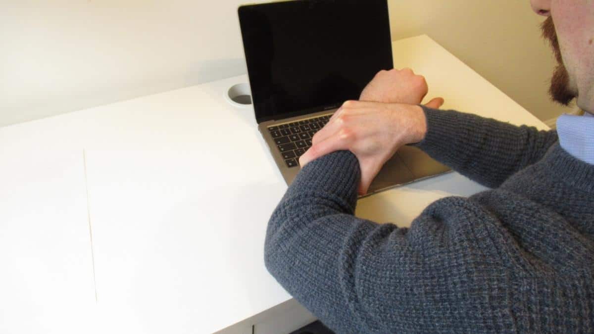 A man with pain in his forearm from typing