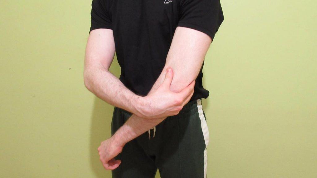 A man with forearm pain near his elbow after trying to grip things