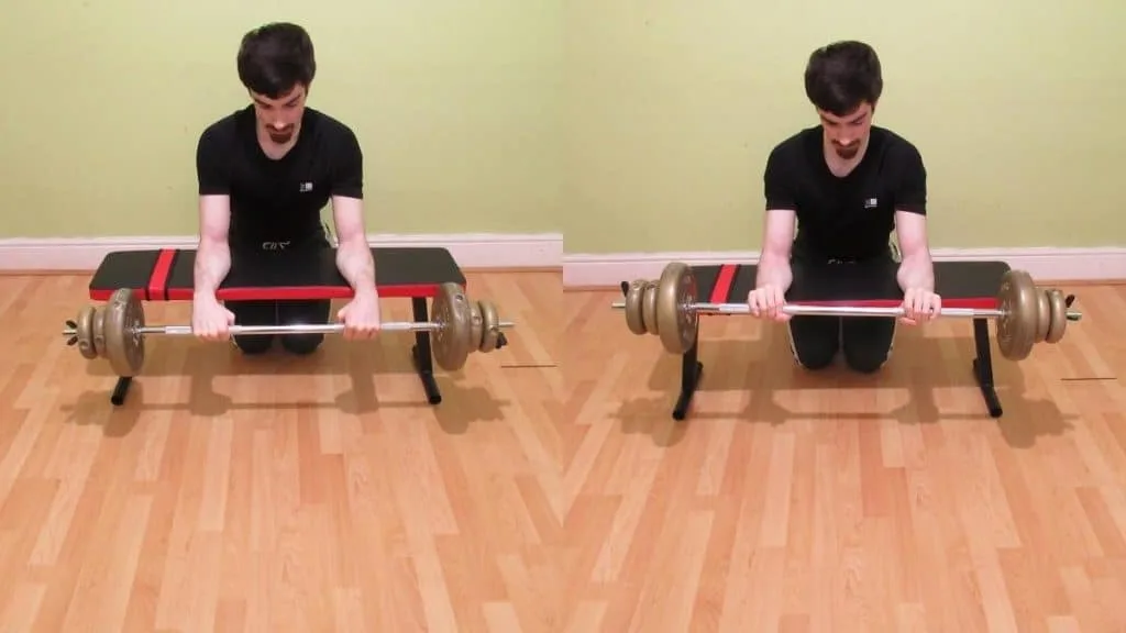 A man doing palm down barbell wrist curls over a bench