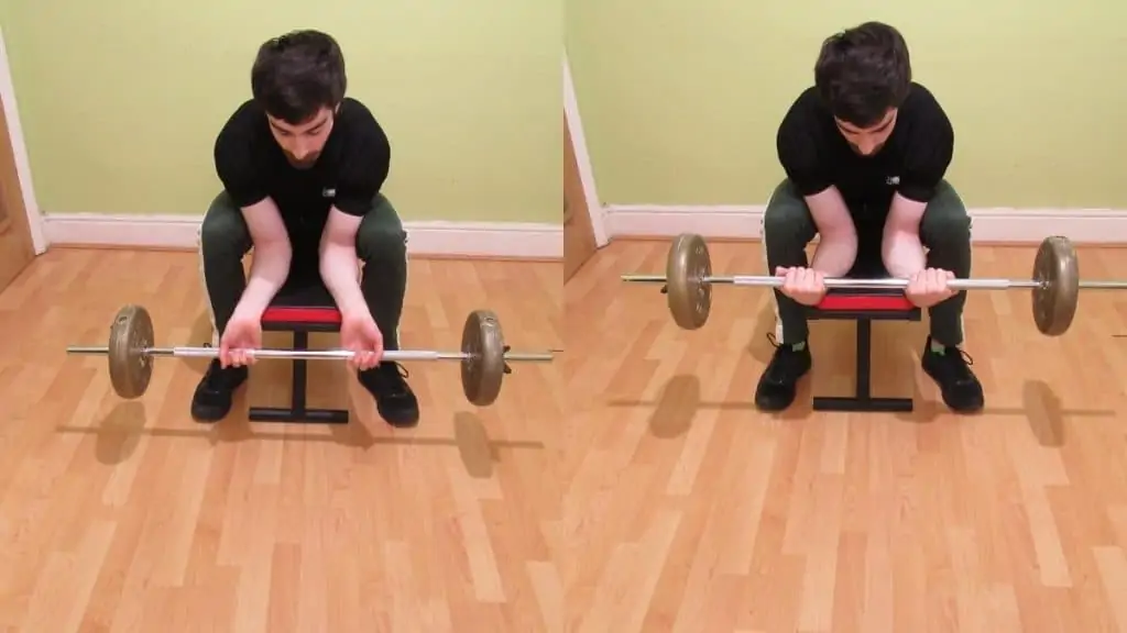 A man doing palm up barbell wrist curls over a bench