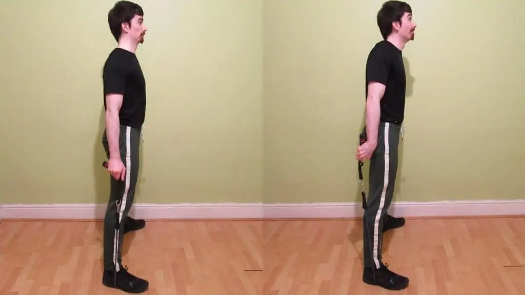 A man performing a resistance band rear rotation