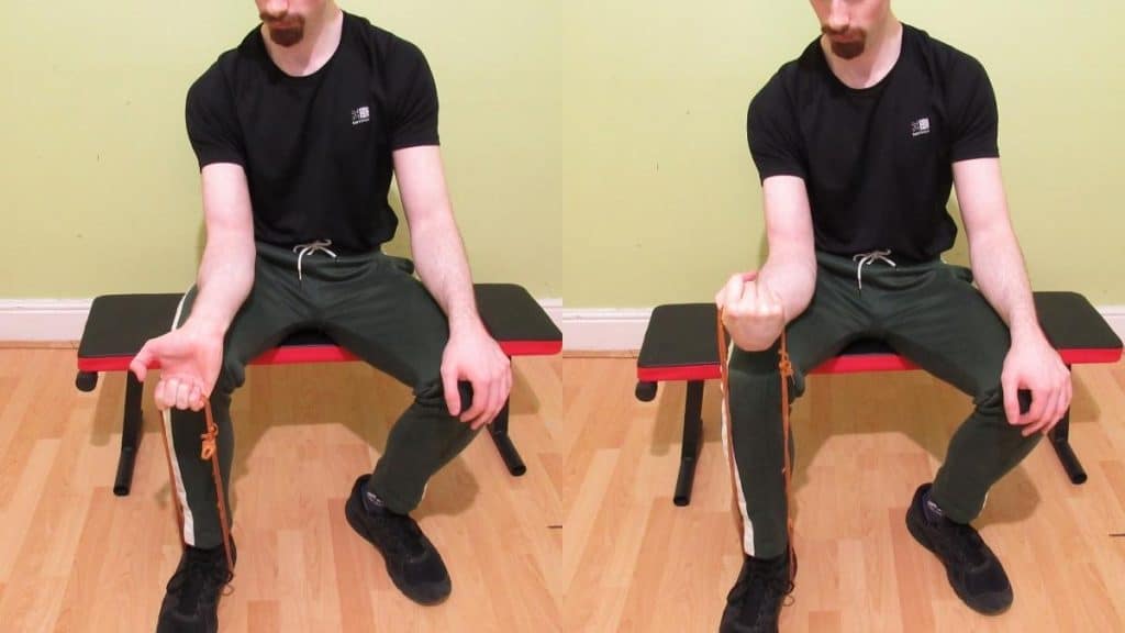 A man doing a resistance band wrist curl for his forearms