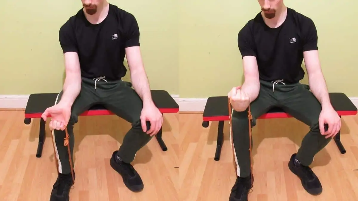 A man doing resistance band forearm curl