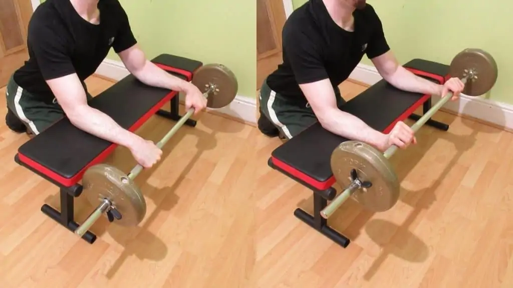 A man performing a reverse barbell forearm curl over a bench