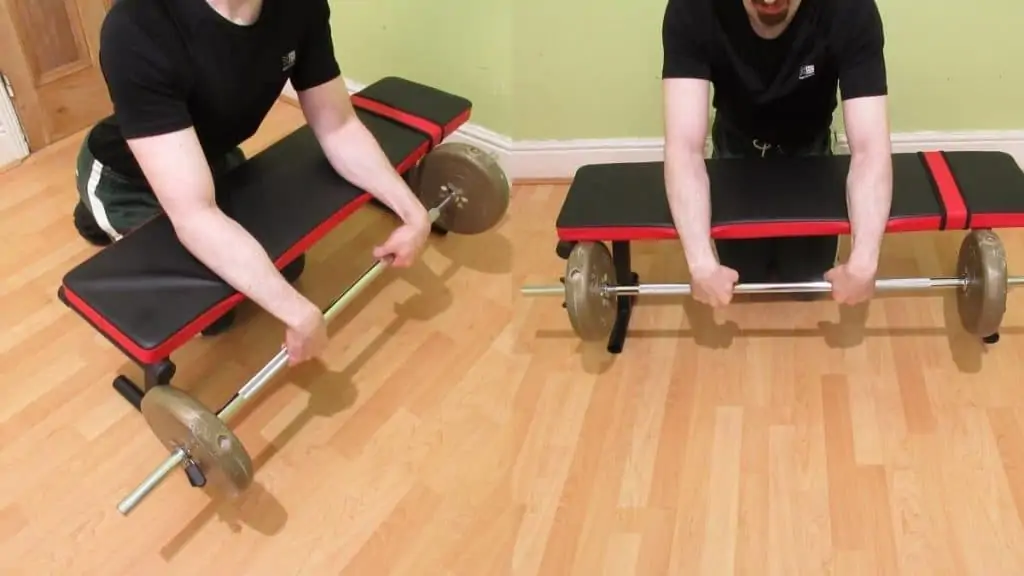 A weight lifter doing a reverse barbell wrist curl