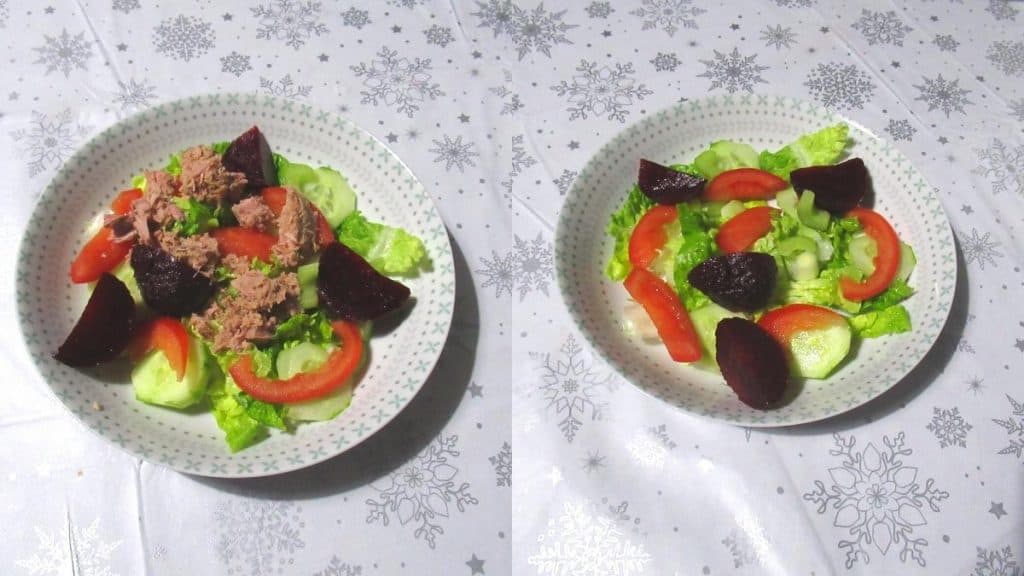 Two salad bowls containing lettuce, peppers, tuna, and more