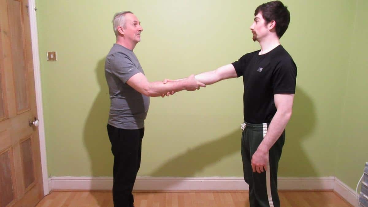 Two men using the Spartan handshake
