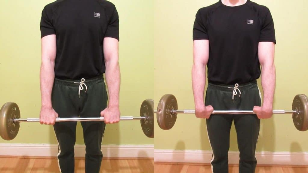 A man performing a standing barbell wrist curl for his forearms