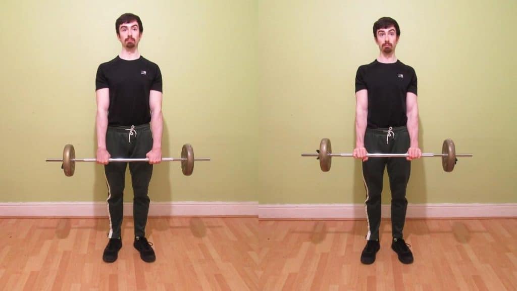A weight lifter doing a standing reverse wrist curl to work his forearms