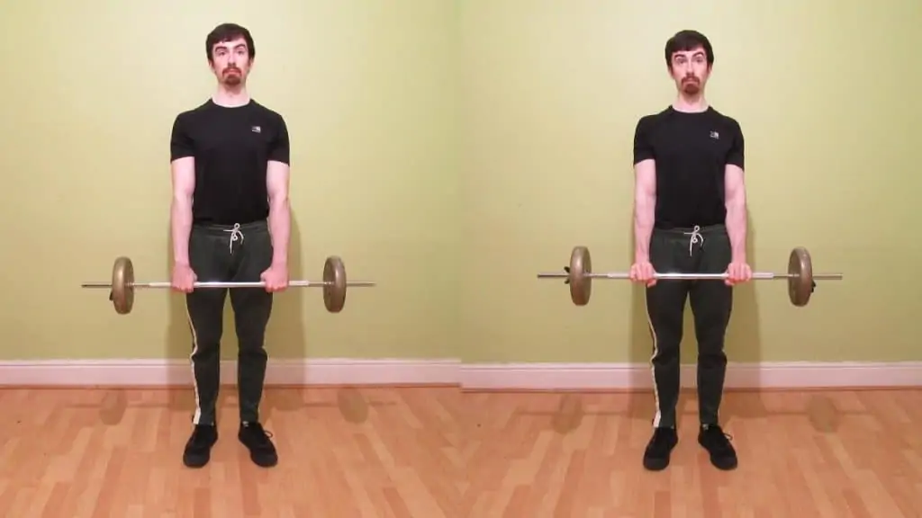 A weight lifter doing a standing reverse wrist curl to work his forearms