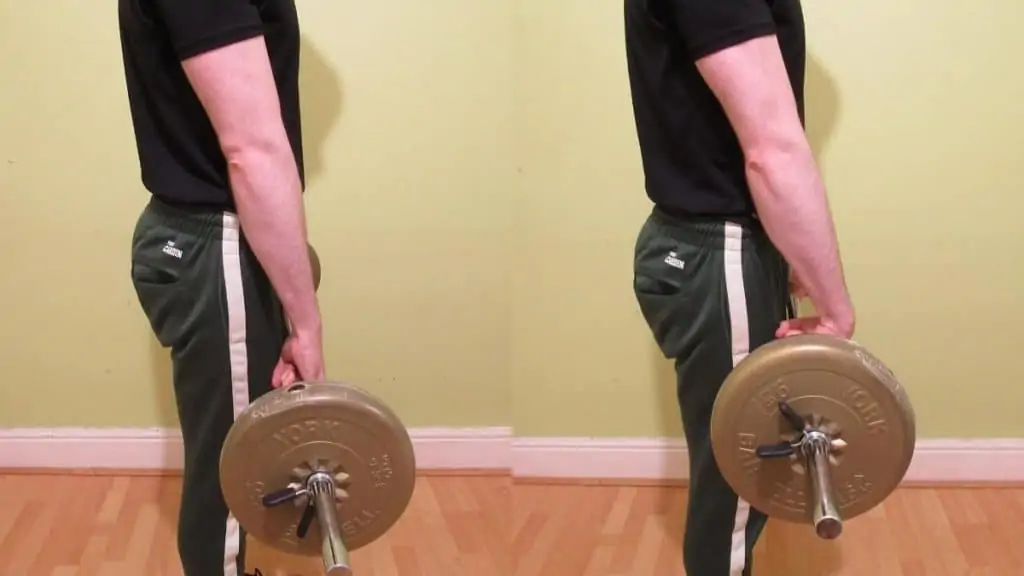 A man performing standing wrist curls for his forearms