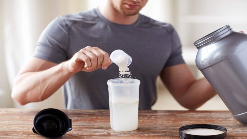 A man taking supplements form a tub