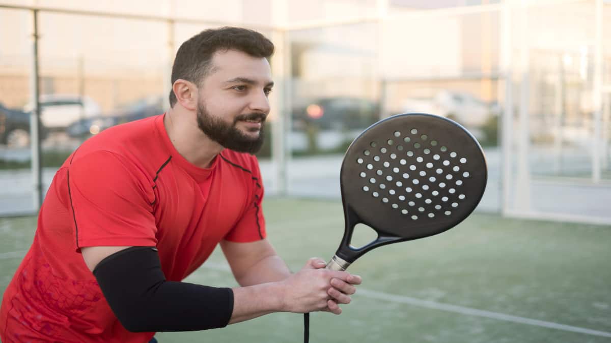 A tennis player holding his racket