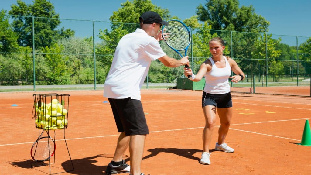 A woman having a tennis lesson