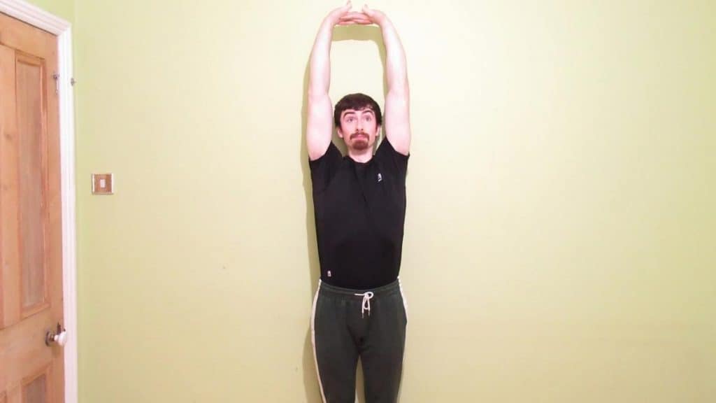 A man stretching his tight forearms