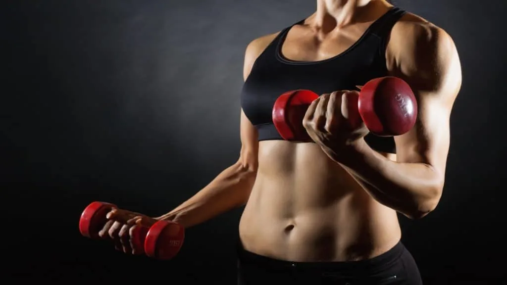 A toned woman lifting weights